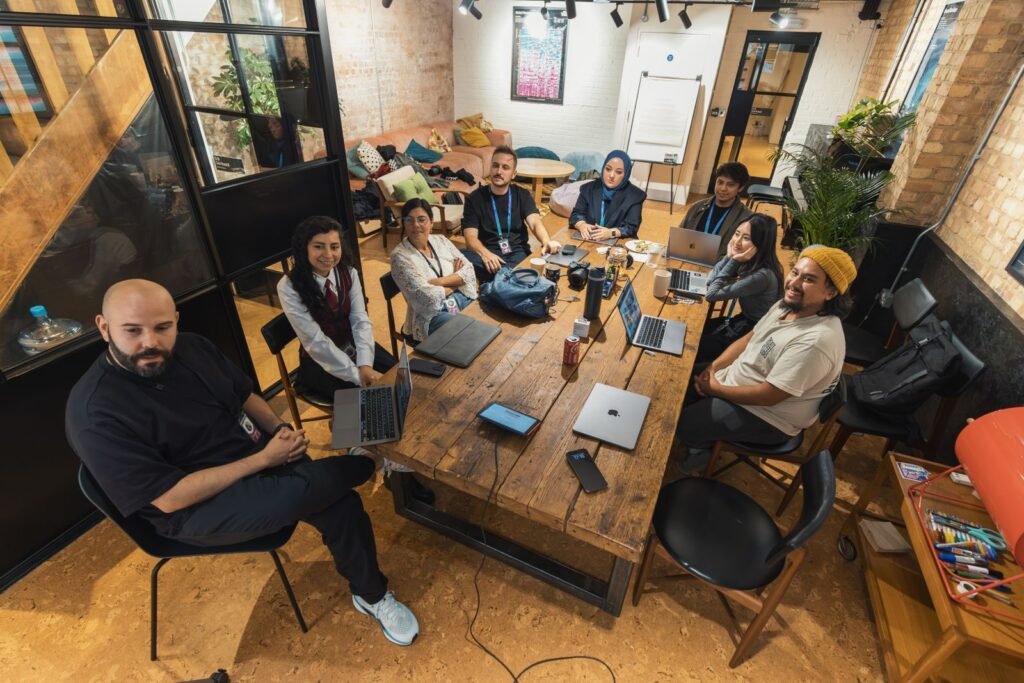Diverse team collaborating in a modern office with laptops