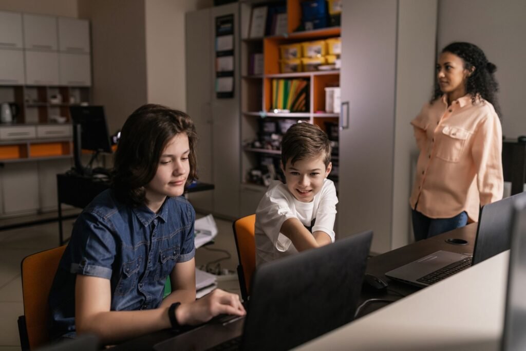 Students learning digital marketing skills on laptops in a classroom